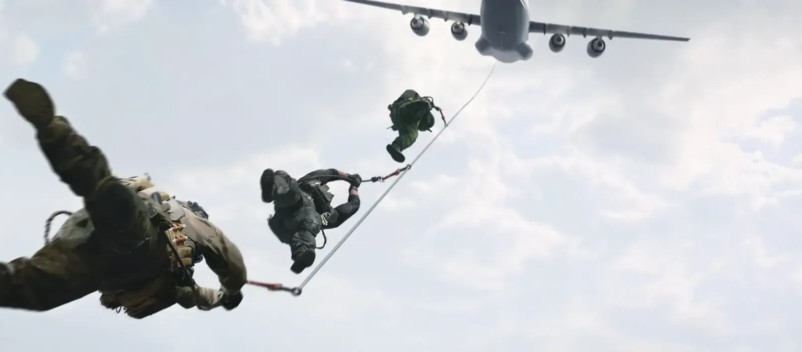 Two operators fast-roping from the rear ramp of a transport aircraft
