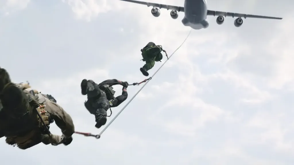 Two operators fast-roping from the rear ramp of a transport aircraft