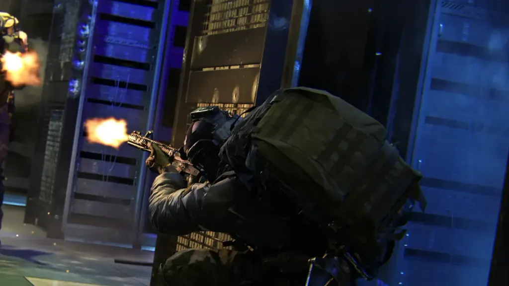 An operator firing down a blue-lit server room while two others advance behind